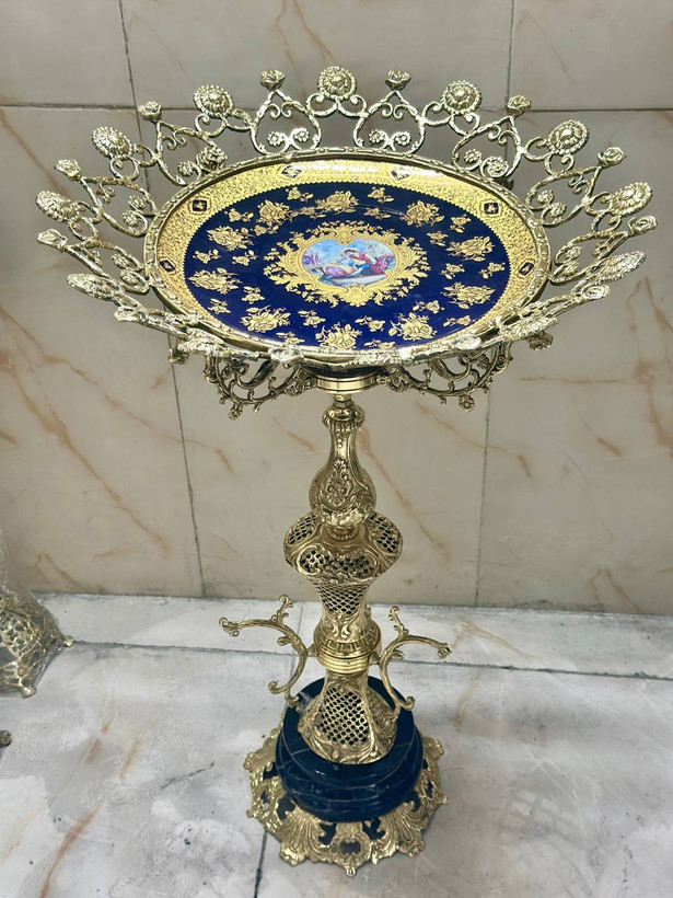 استند و پایه کنار سالنی مجلل برنجی با ستون مشبک طرح زنبوری و نقوش برجسته گل قلبی با نشیمن مدور بازرگانی نداف مشهد